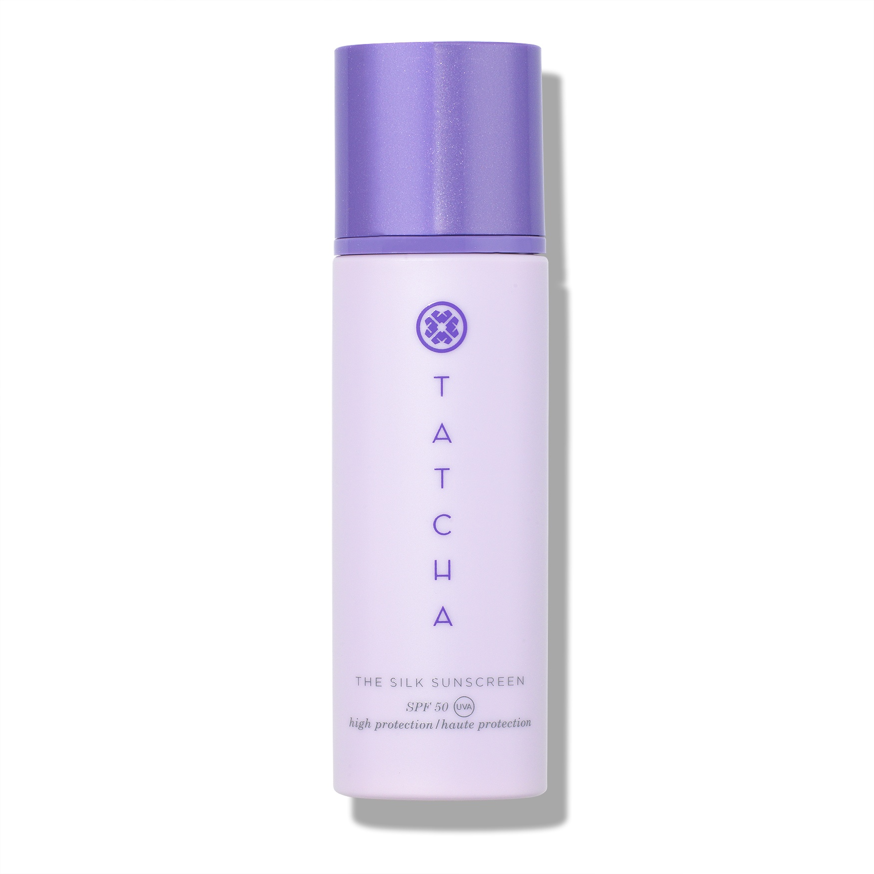 Light purple cylindrical bottle with a lavender cap, featuring "Tatcha" and "The Silk Sunscreen SPF 50" printed in elegant font, emphasizing high protection.