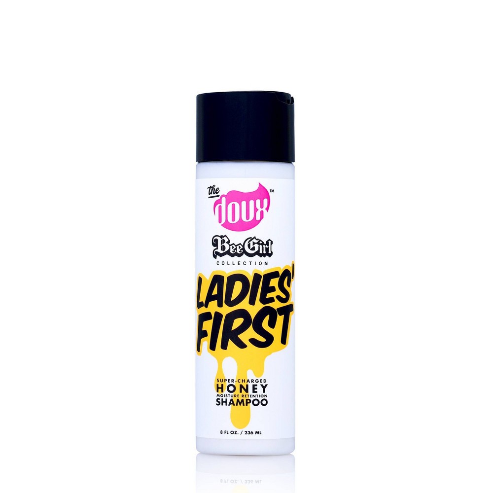 White bottle with a pink cap, featuring bold black and yellow text that reads "The Doux Bee Girl Ladies First Shampoo" and "Super Enriched Honey Shampoo," 8 oz size.