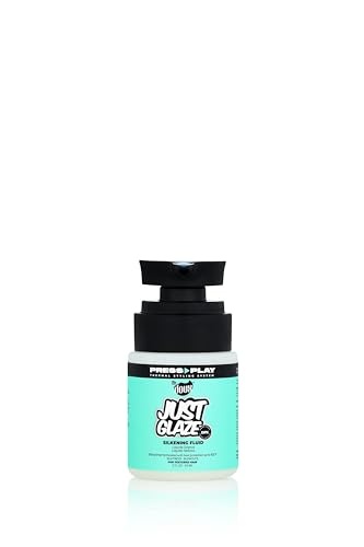 A small, clear bottle with a black pump top, featuring a turquoise label that reads "Just Glaze Silkening Fluid" in bold white text, designed by The Doux.
