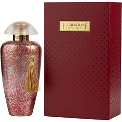 Elegant red bottle with intricate white rose patterns, topped with a clear dome cap, accompanied by a gold tassel, alongside a matching red box with gold accents.