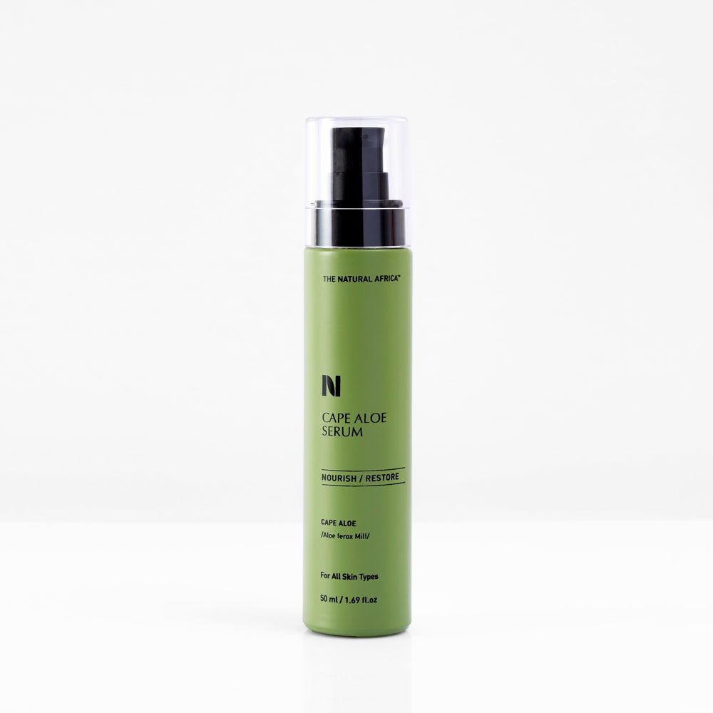 Green cylindrical bottle with a black pump top, labeled "Cape Aloe Serum" by The Natural Africa, designed for all skin types, emphasizing nourishment and restoration.