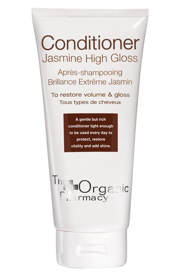 White tube of Jasmine High Gloss Conditioner by The Organic Pharmacy, featuring a sleek design with brown text, promising to restore volume and gloss for all hair types.