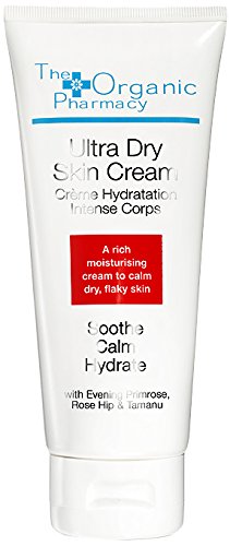 White tube of Ultra Dry Skin Cream by The Organic Pharmacy, featuring a red label, 100ml size, with key ingredients like evening primrose and rose hip for hydration.