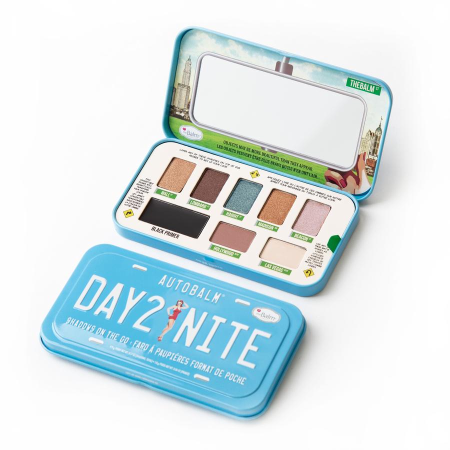 TheBalm Autobalm Shadows on the Go Palette features a light blue metal case with a mirror, containing one eye primer and seven eyeshadows in various shades, including matte and shimmer finishes.