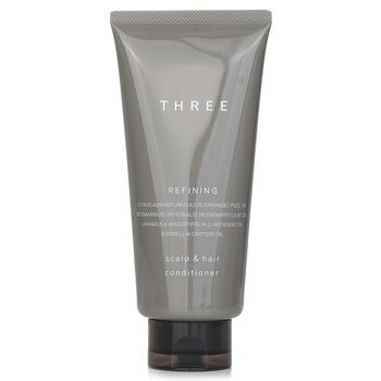 Gray tube of THREE Scalp & Hair Refining Conditioner, featuring a sleek design with white text, 165g/5.8oz, highlighting key ingredients like citrus and essential oils.