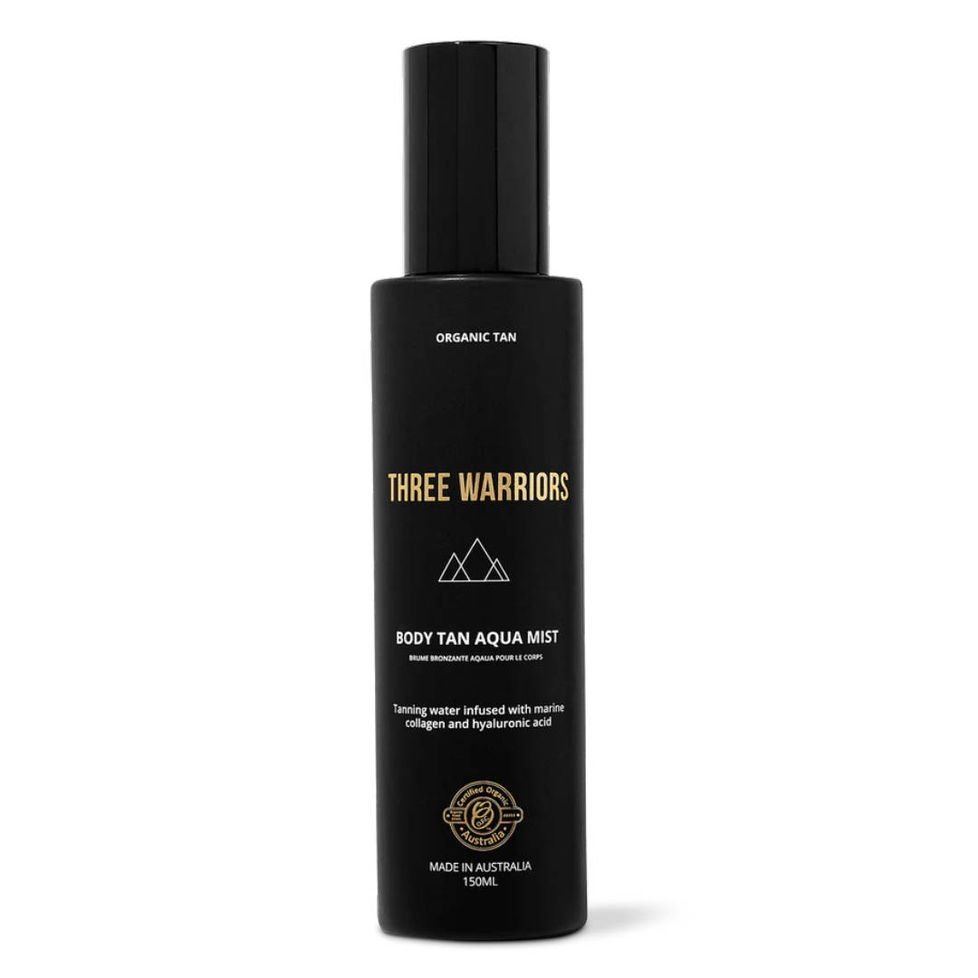 Black spray bottle with gold text labeled "THREE WARRIORS BODY TAN AQUA MIST," featuring a sleek design and 150ml capacity, highlighting marine collagen and hyaluronic acid.