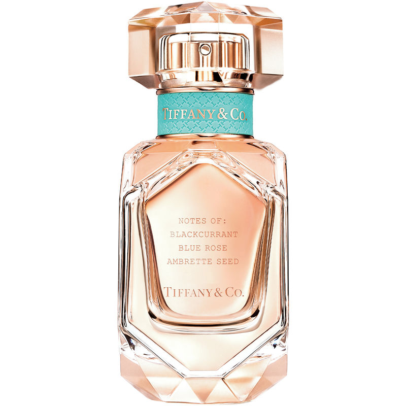 Tiffany Rose Gold Eau De Parfum in a faceted glass bottle with a hexagonal shape, featuring a light pink liquid, a turquoise ribbon, and engraved notes on the front.