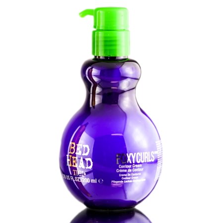 Tigi Foxy Curls Curly Hair Cream in a purple, curvy bottle with a green pump top, labeled "Foxy Curls" and containing 200ml for defined curls.