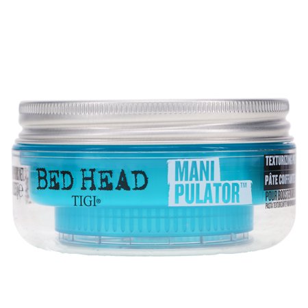 Clear jar with a silver lid containing blue texturizing putty labeled "Bed Head by TIGI Manipulator," featuring bold black and white text on the sides.