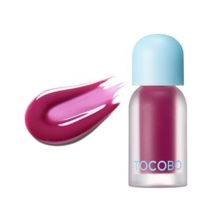 Tinted lip oil in a clear bottle with a light blue cap, featuring a rich berry shade, with a swatch of the same color beside it, emphasizing its plumping effect.