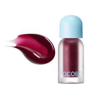 Tocobo Juicy Berry Plumping Lip Oil in Plum Jam, featuring a clear bottle with a light blue cap and a rich plum-colored oil swatch beside it.