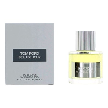 Clear glass bottle with a silver cap, containing yellow eau de parfum, next to a sleek gray box labeled "Tom Ford Beau De Jour" in white text.