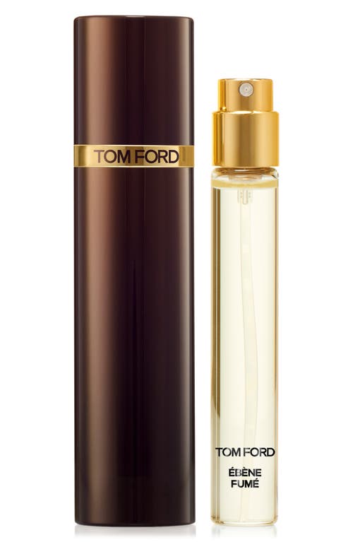 A sleek, dark brown cylindrical case with a gold band encases a clear glass spray bottle labeled "Ébène Fumé" in black, featuring a gold spray nozzle.