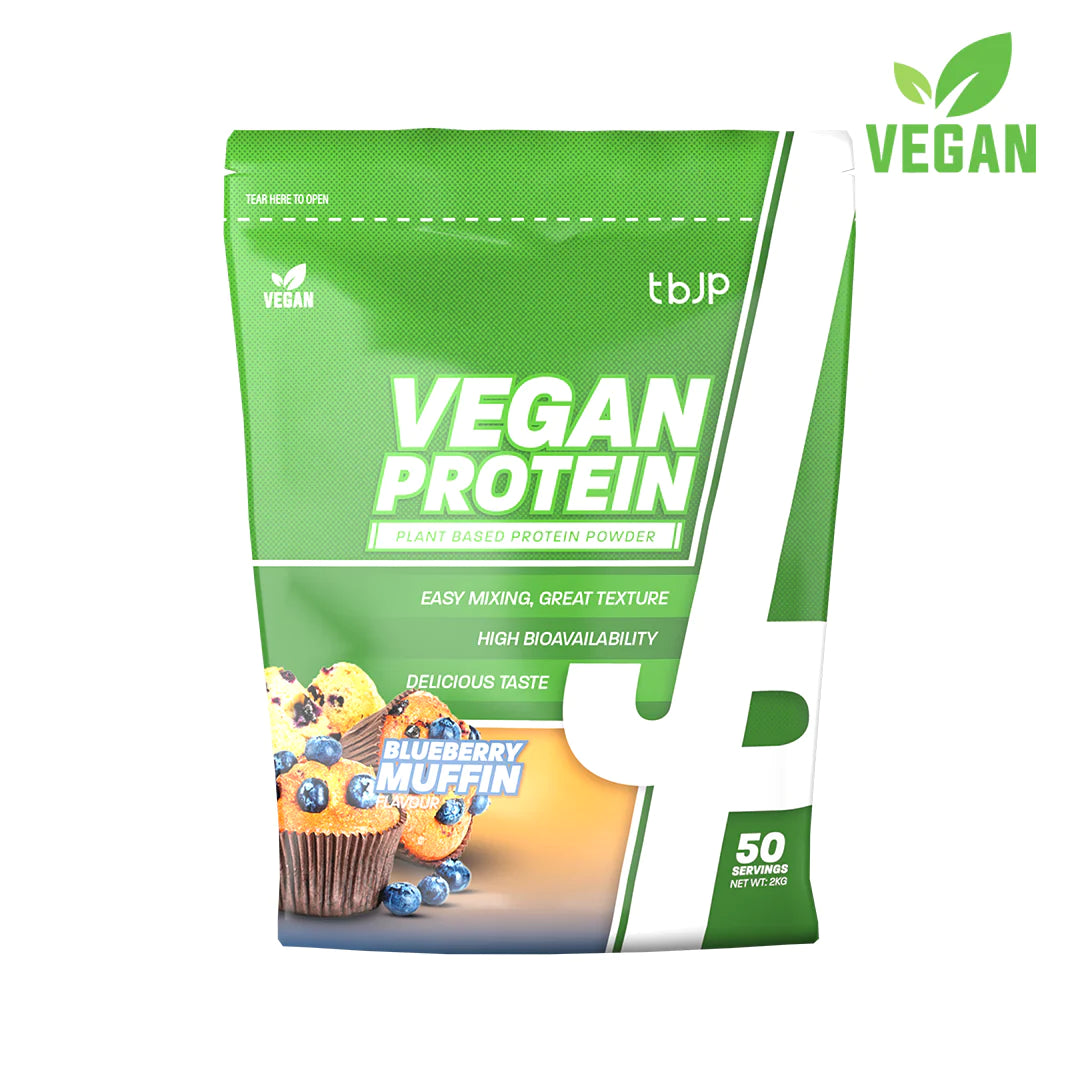 Bright green bag of Trained by JP Plant Based Vegan Protein, 2kg, featuring a blueberry muffin design, with text highlighting easy mixing, great texture, and delicious taste.