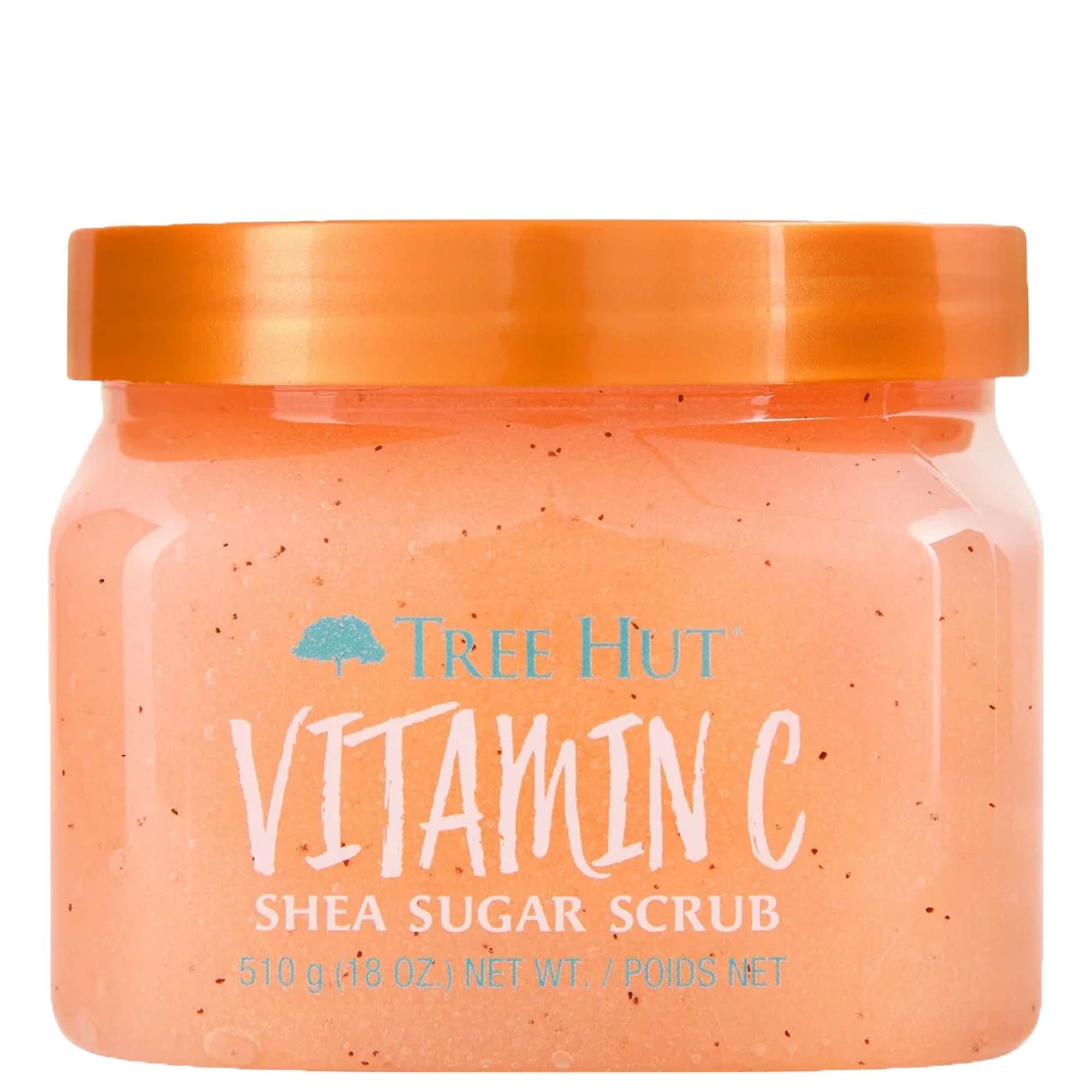 A clear jar of Tree Hut Vitamin C Shea Sugar Scrub, featuring a bright orange scrub inside, an orange lid, and blue text on the front label.