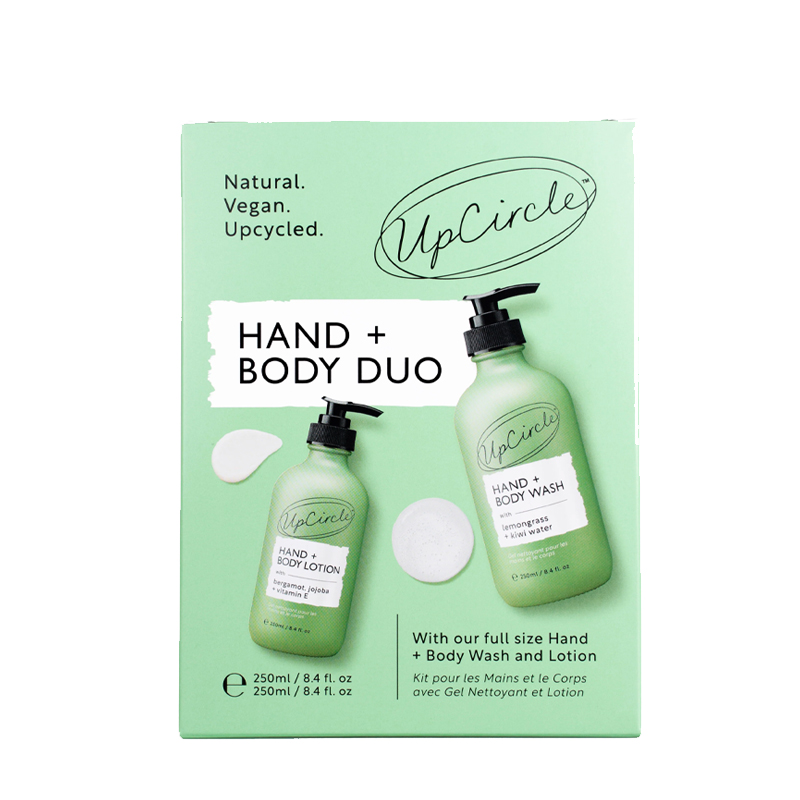 Green packaging featuring UpCircle's Hand + Body Duo, including a hand wash and lotion in clear bottles, both labeled with natural, vegan, and upcycled claims.