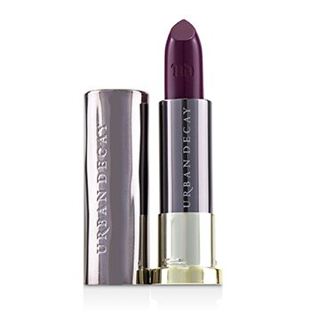 Dark purple lipstick in a sleek silver tube with gold accents, featuring the Urban Decay logo embossed on the side.