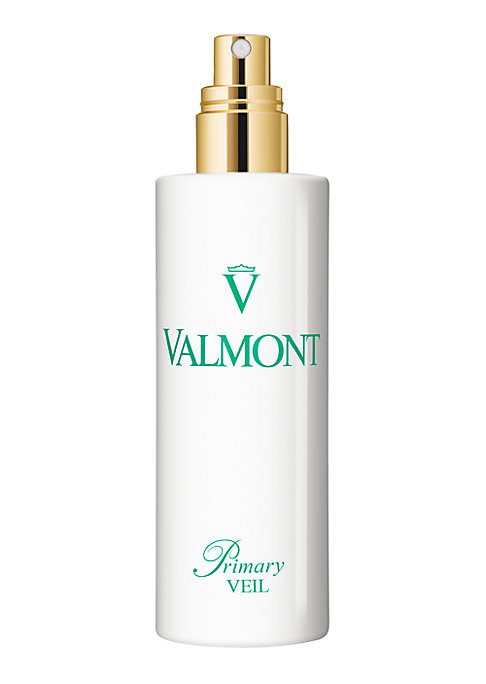 White cylindrical bottle with a gold spray nozzle, featuring a green logo and text reading "Valmont Primary Veil" on the front.