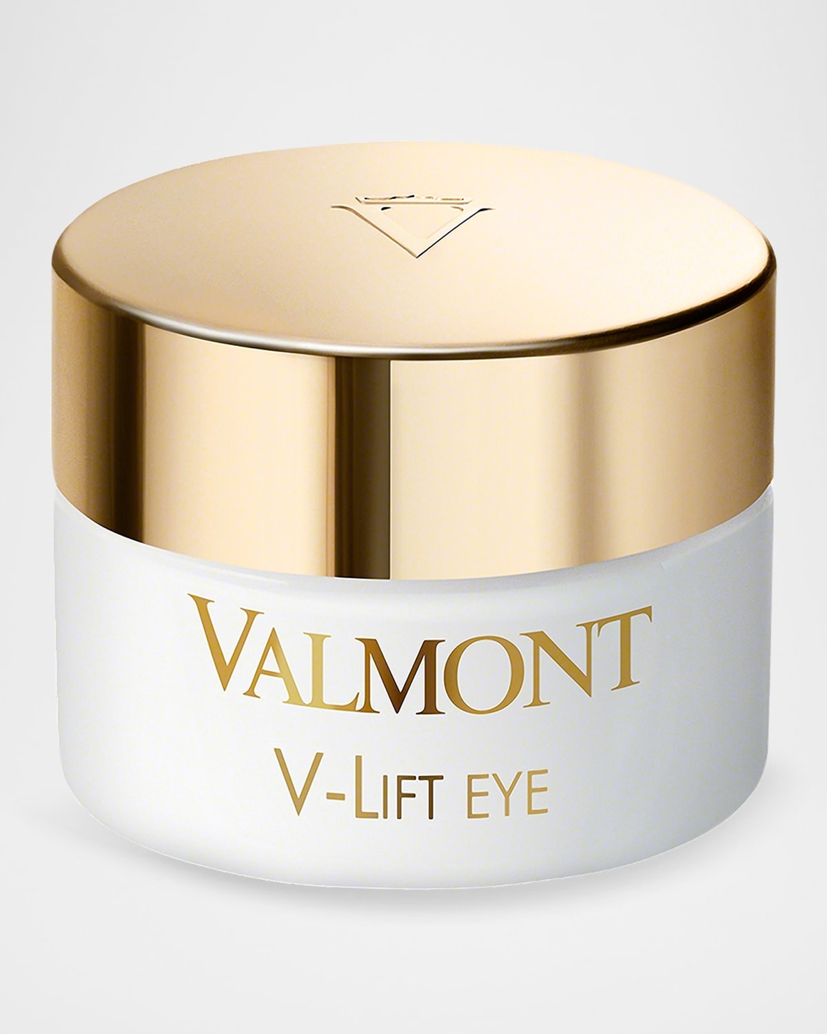 White cream jar with a gold lid, featuring the brand name "Valmont" and product name "V-Lift Eye" in elegant lettering.