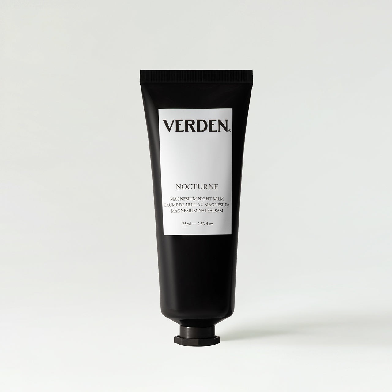 Black tube of Verden Nocturne Magnesium Night Balm, 75ml, featuring bold white text on the front, with a sleek design and a black screw cap.