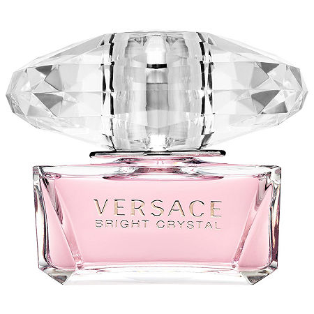 Clear glass bottle with a faceted crystal-like cap, featuring a soft pink liquid and the engraved text "VERSACE BRIGHT CRYSTAL" on the front.