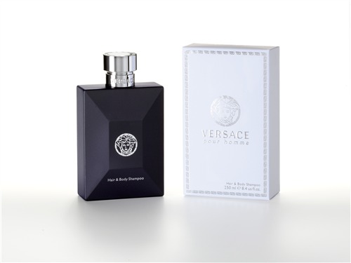 Black rectangular bottle with a silver cap, featuring the Versace logo, alongside a white box with a decorative border, labeled "Hair & Body Shampoo 8.4 Oz."