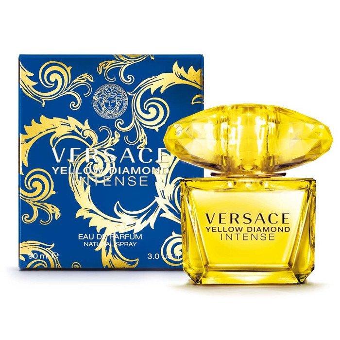 Versace Yellow Diamond Intense EDP spray in a clear glass bottle with a yellow cap, accompanied by a blue and gold ornate box featuring the Versace logo.