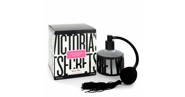 Victoria's Secret Love Me Eau De Parfum 50ml features a sleek black and white bottle with a stylish atomizer and a tassel, set against a matching box with bold text.