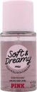Clear glass bottle of Victoria's Secret Pink Soft & Dreamy Fragrance Mist with a light pink cap, featuring a round label with bold black text on a soft pink background.