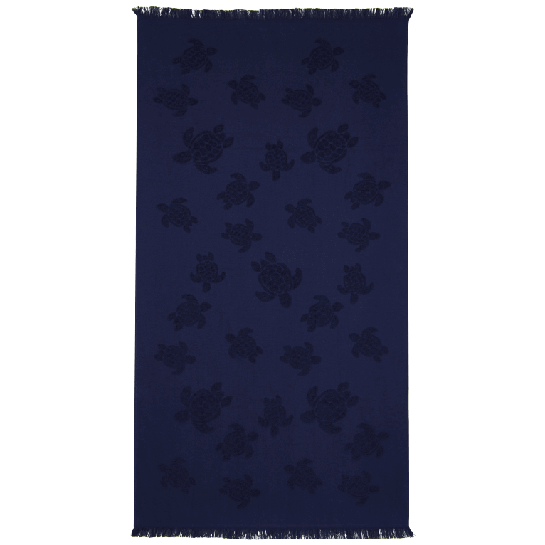 Blue organic cotton beach towel featuring a jacquard design of turtles, with a fringed edge, measuring OSFA.
