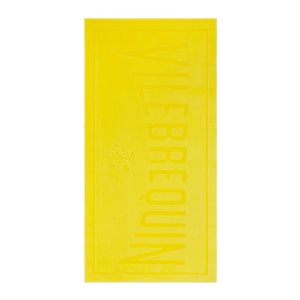 Bright yellow solid organic cotton beach towel featuring the embossed brand name "Vilebrequin" and a turtle logo, designed for versatile beach use.