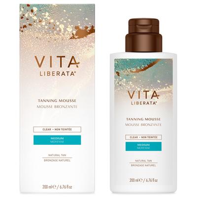 Clear tanning mousse in a white bottle with a pump dispenser, labeled "Vita Liberata" in bold letters, alongside a colorful box featuring blue and gold accents, 200ml size.