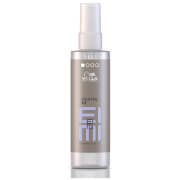 Clear bottle of Wella EIMI Cocktail Me, 100ml, featuring a sleek design with a silver cap and a light grey label displaying the product name in bold, modern lettering.