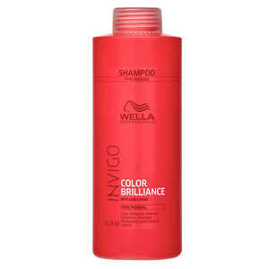 Bright red bottle of Wella Professionals Invigo Color Brilliance shampoo for fine and normal hair, featuring a flip-top lid and labeled with color protection details, 1000 ml volume.