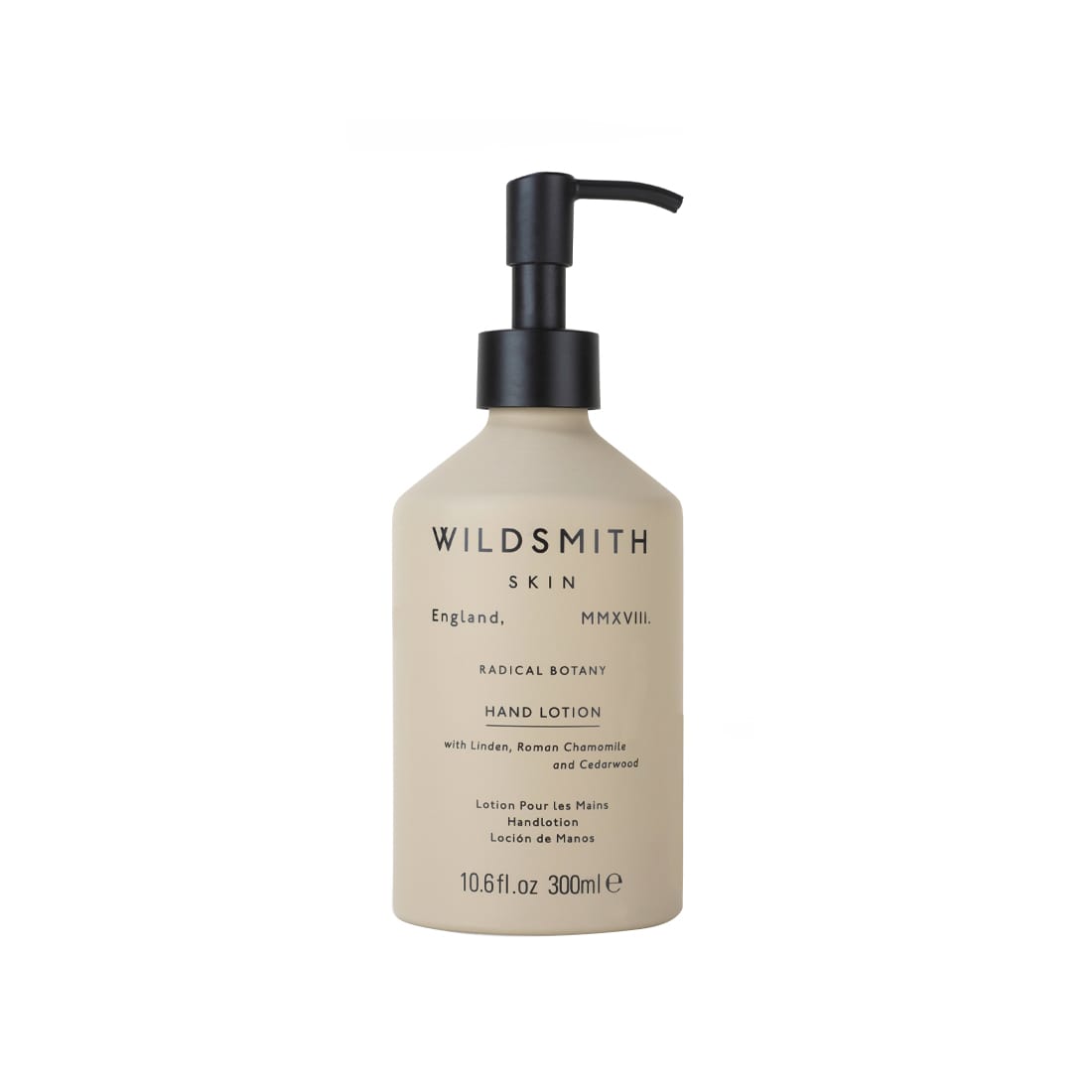 Cream-colored aluminum bottle with a black pump top, labeled "WILDSMITH SKIN," featuring details about the hand and body lotion's benefits and ingredients.