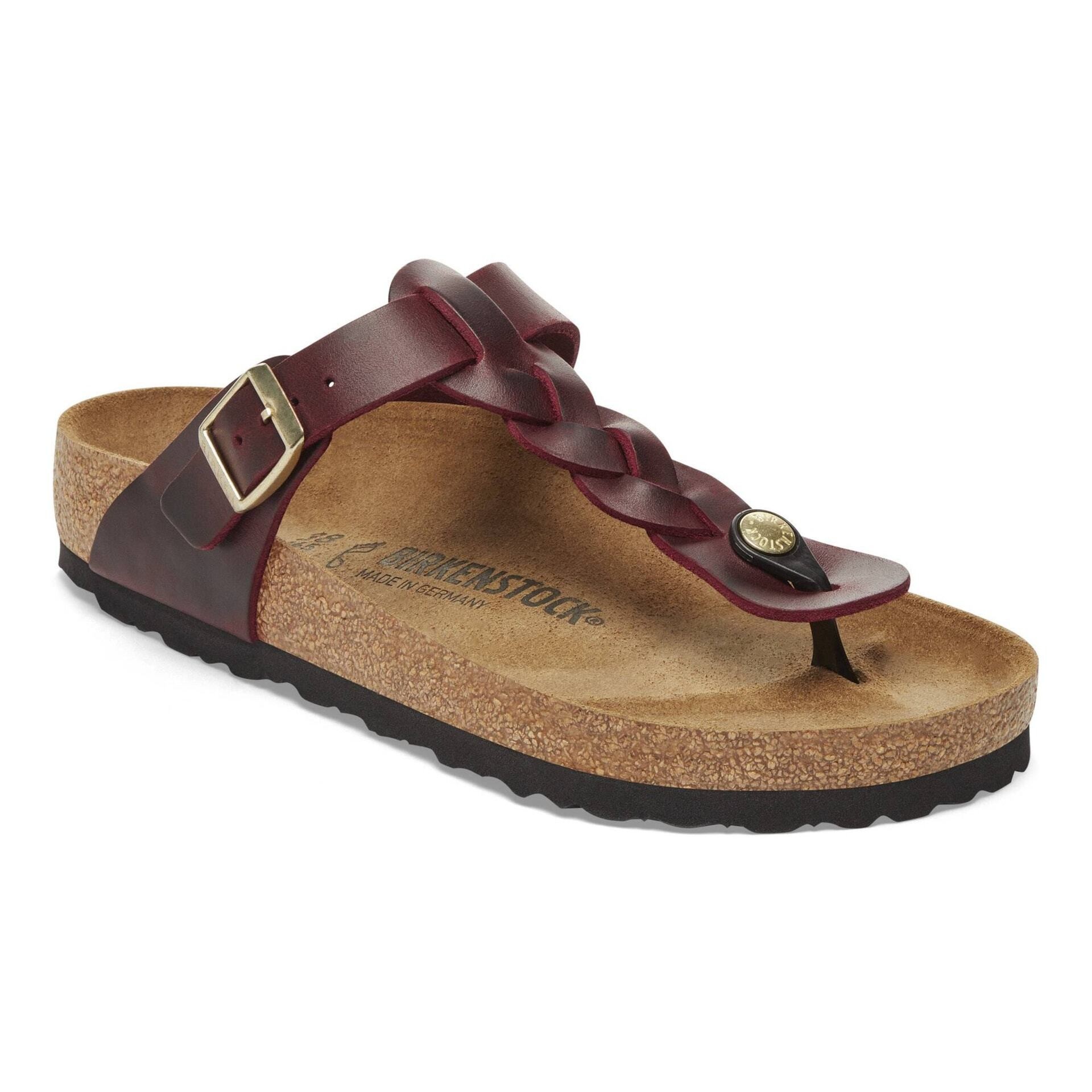 Burgundy Birkenstock Gizeh flip-flops made of oiled leather, featuring a braided strap, adjustable buckle, and a cork footbed with a textured black sole.