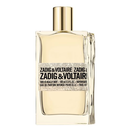 Clear glass bottle with a rectangular shape, featuring a gold cap and a textured label that reads "Zadig & Voltaire This Is Really Her! Eau De Parfum 100ml Spray."