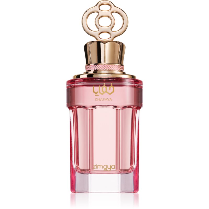 Clear glass perfume bottle with a pink tint, featuring a gold cap adorned with a circular design, labeled "Zimaya Khafaya Pink" in elegant script.