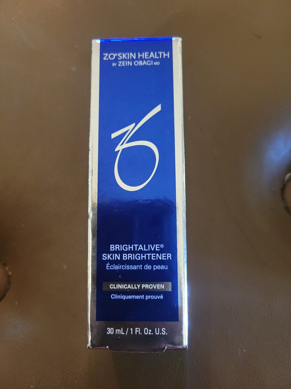 ZO Skin Health Brightalive Skin Brightener in a sleek blue and silver box, featuring bold white text and a clinical claims label, sized at 1 Fl Oz (30 mL).