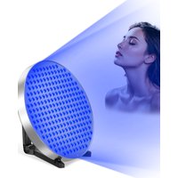 Round silver 50W tanning lamp with 250 blue LED lights, projecting light onto a woman's face, includes eye mask.