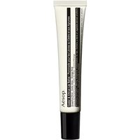 White Aesop lip salve tube with black text, cedar and citrus formula, 9 ml size, sleek design for dry skin nourishment.