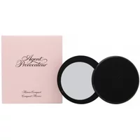 Black round compact mirror with pink Agent Provocateur pouch and elegant script branding.