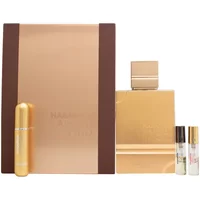Al Haramain Amber Oud Gold Edition perfume, gold rectangular bottle with matching cap, alongside a gold box.