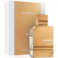 Amber Oud White Edition perfume in a gold rectangular bottle with matching cap, beside a white and gold box.