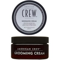 Black and white American Crew Grooming Cream jar with black lid, 85g, featuring bold text and minimalist design.