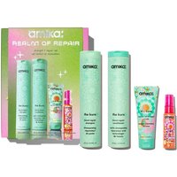 Amika Realm Of Repair set with green bottles, colorful tube, and spray, in a vibrant box with star graphics.