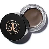 Black jar of Anastasia Beverly Hills Dipbrow Pomade in Soft Brown with logo on lid and creamy brown pomade inside.
