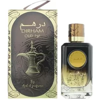 Dirham Oud perfume bottle, black and gold gradient with gold cap, next to ornate box with Arabic script.