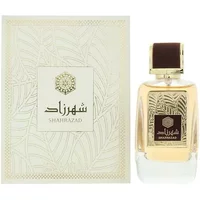 Clear glass bottle of Ard Al Zaafaran Shahrazad Eau De Parfum with gold cap and ornate box design.
