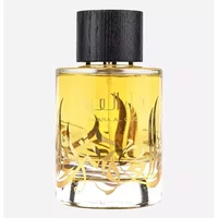 Clear glass bottle of Ard Al Zaafaran Thara Al Oud Eau De Parfum with black cap and gold Arabic script, 100ml.